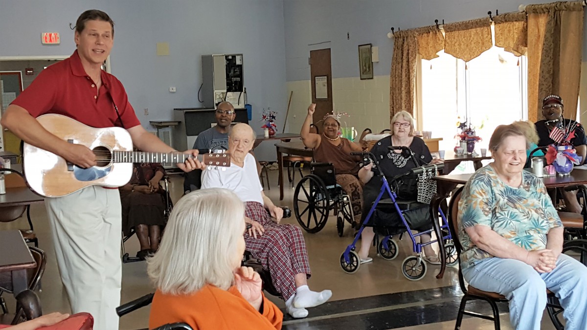 Residents enjoying a musical performance at a nursing home.