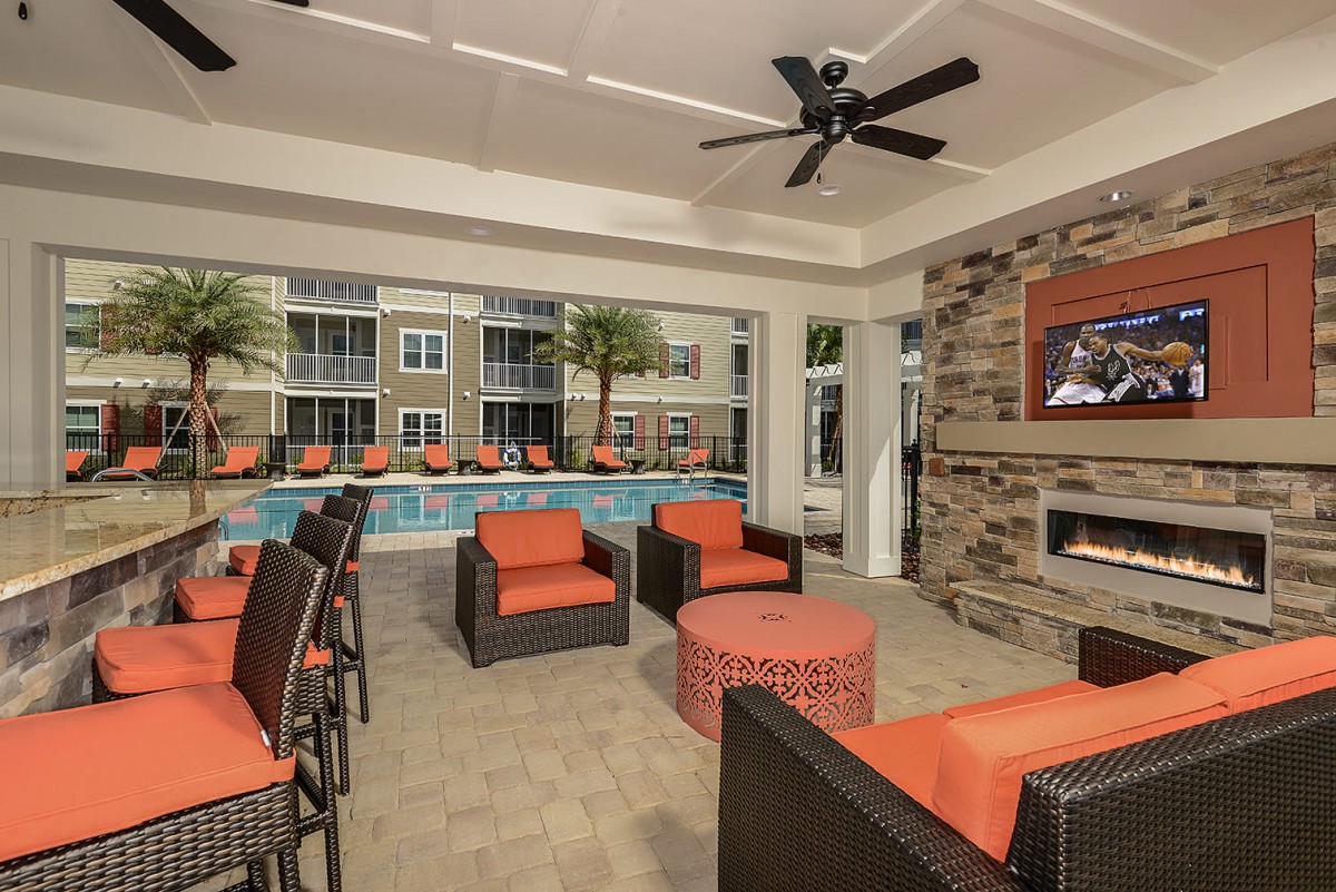 Modern indoor lounge area with pool view and comfortable seating.
