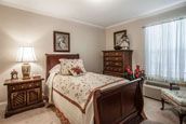 A cozy bedroom with traditional furniture and decorative accents.