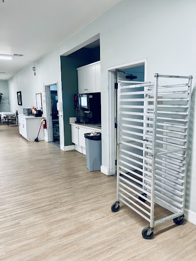 A view of a healthcare facility's waiting area with a kitchen cart positioned nearby.