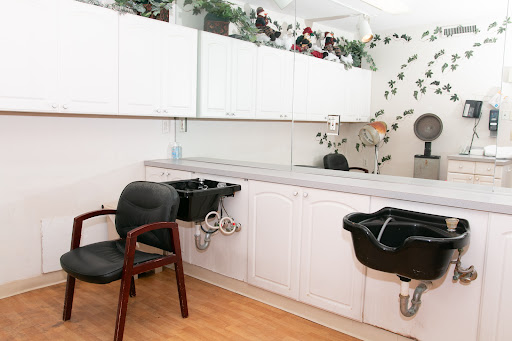 A clean and organized hair salon interior featuring styling chairs, mirrors, and modern decor.