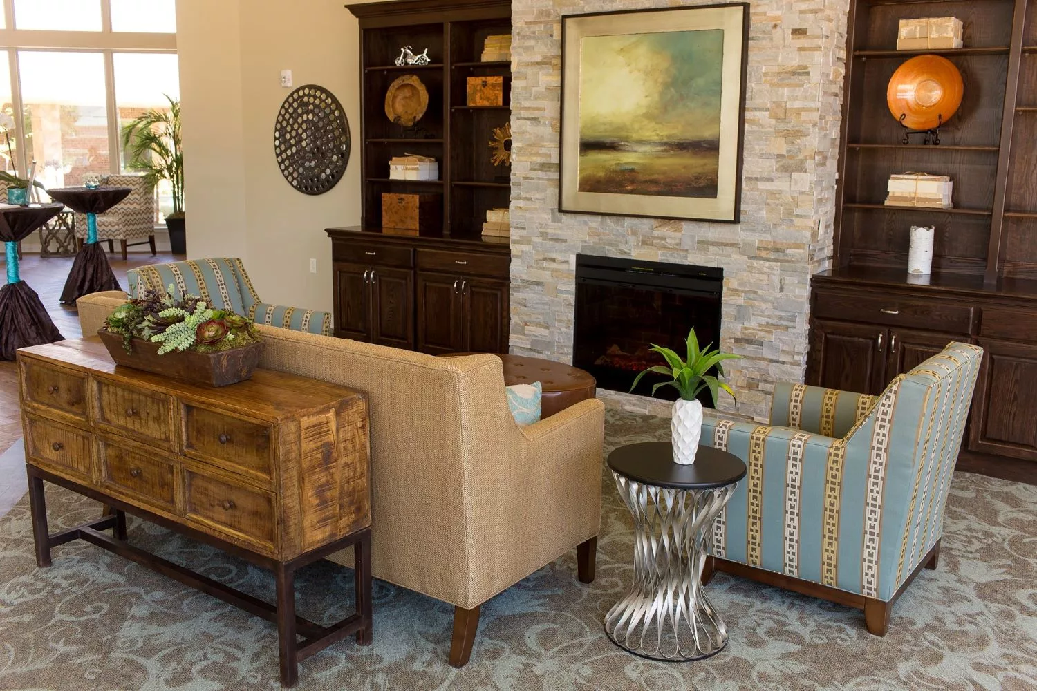 A modern living room with a cozy fireplace, stylish furniture, and tasteful artwork.