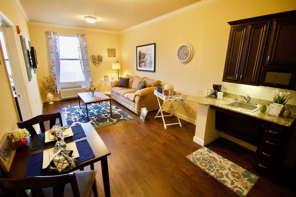 A cozy apartment living room with comfortable furniture and a dining area.