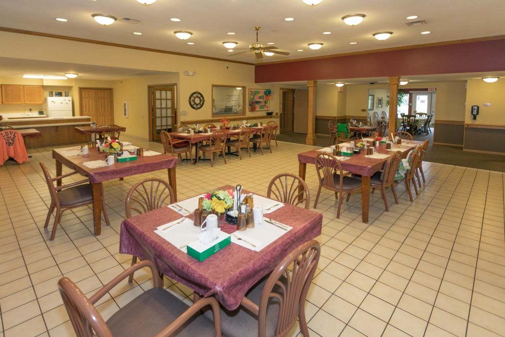 An empty dining area with set tables, featuring a warm and inviting atmosphere.