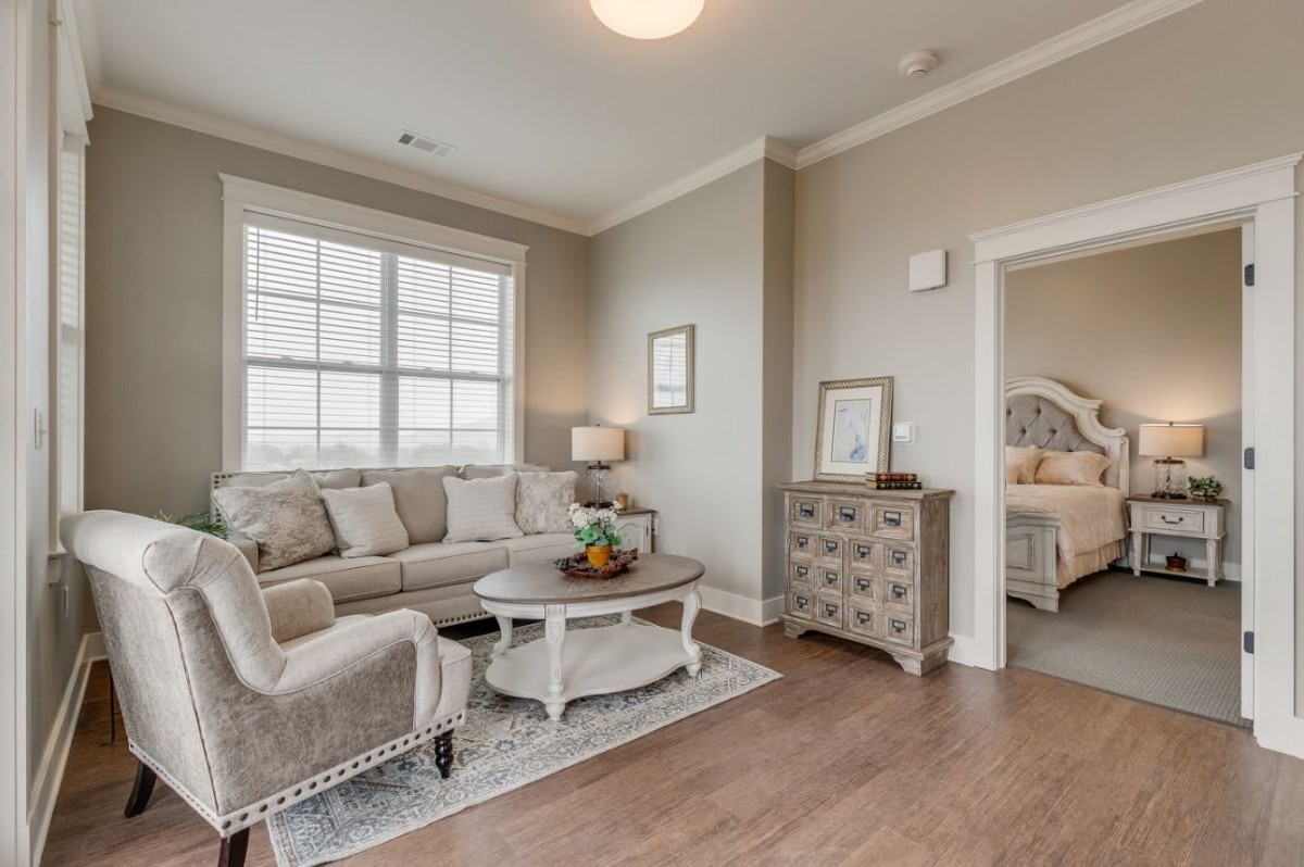 A cozy living room with a beige couch, coffee table, and elegant decor.