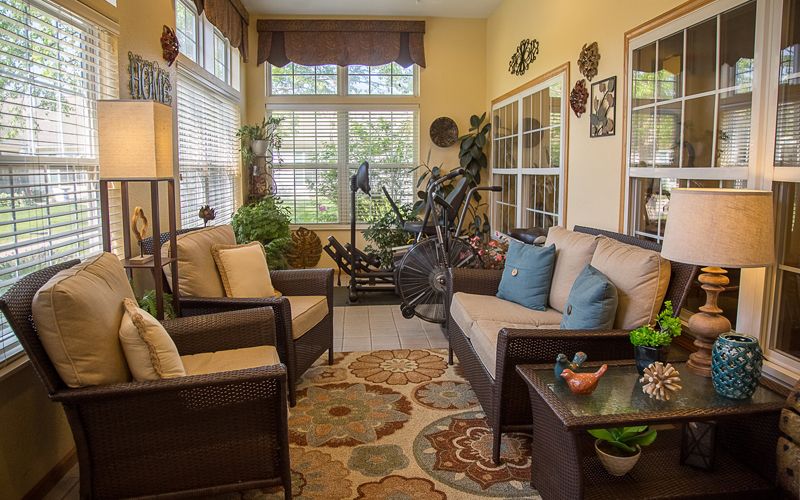A cozy living room with comfortable seating and lush indoor plants.