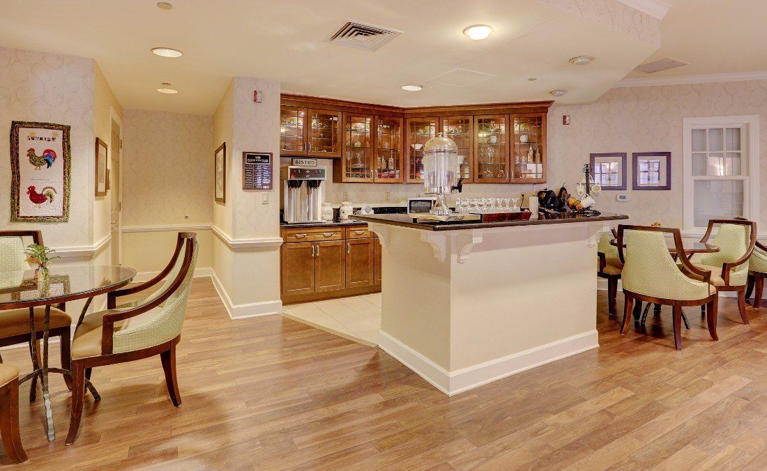 A cozy kitchen area with wooden cabinets and a seating space.