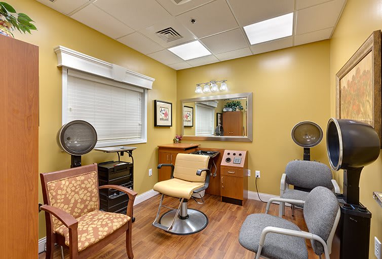 A cozy hair salon interior with chairs, mirrors, and salon equipment.