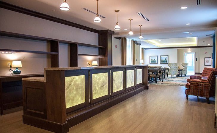A modern hotel lobby featuring a well-lit reception desk and stylish interior design.