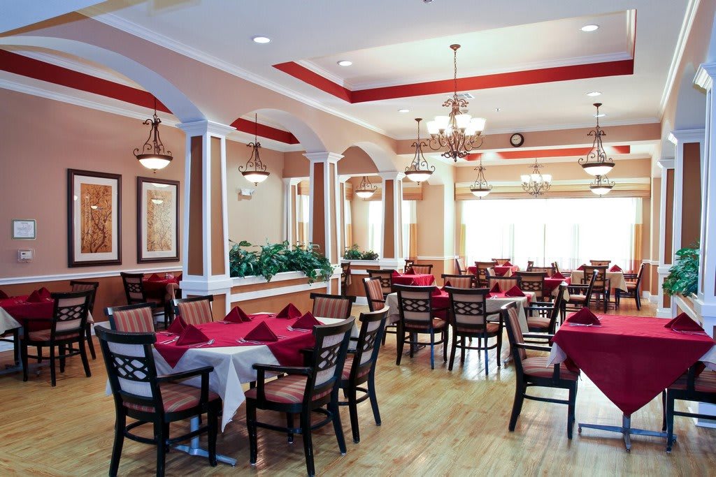 A spacious and elegantly designed dining area with tables set for service.
