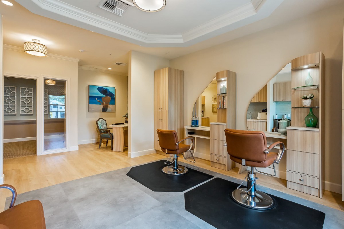 A modern hair salon interior with styling chairs and mirrors.