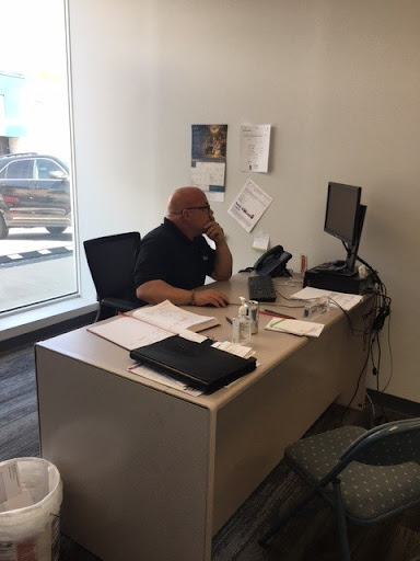 A person engaged in a phone call at their office desk.