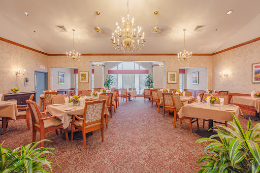 An elegant dining room setup featuring chandeliers and inviting tables for guests.