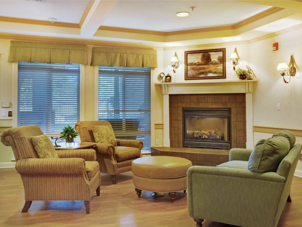 A cozy living room with comfortable seating and a warm fireplace.