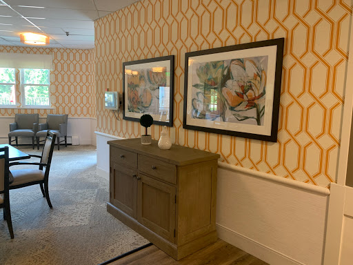 A stylish dining area featuring elegant wall art and a modern sideboard against a geometric patterned wall.