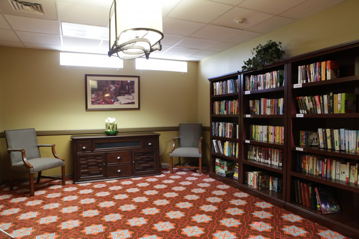 A cozy library corner with bookshelves and a comfortable reading chair.