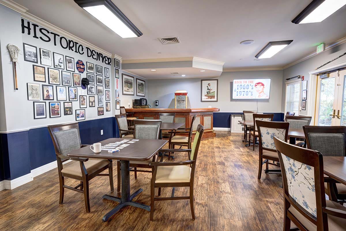 A well-arranged restaurant dining area featuring multiple tables and chairs, with decorative elements adorning the walls.