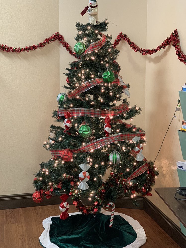 A beautifully decorated Christmas tree with lights and ornaments, adding a festive touch to the room.