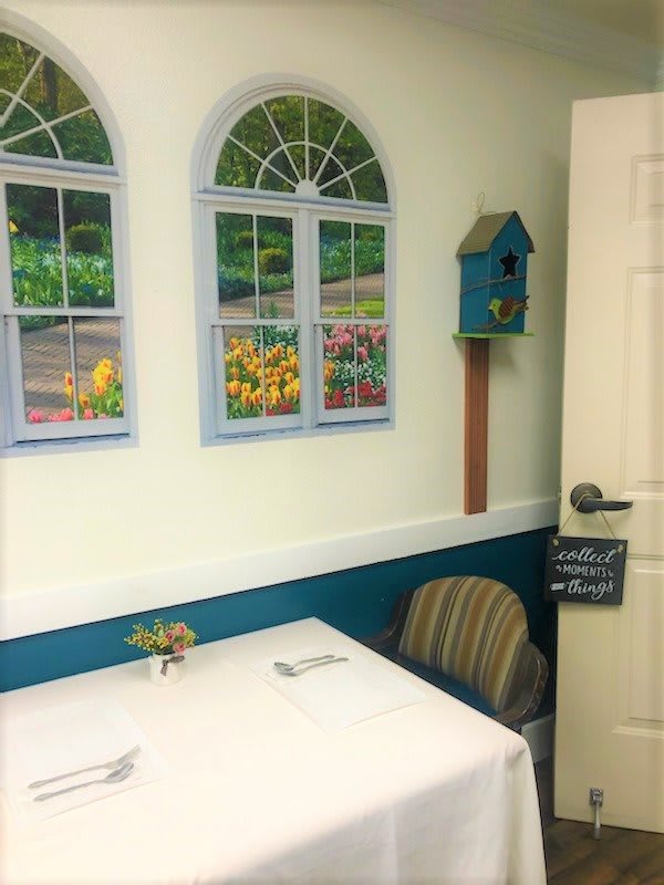 A cozy dining area with wall decorations and a small table.