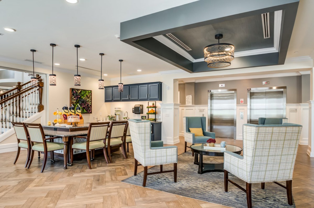 A modern open-concept living area featuring a dining and kitchen space with contemporary furniture and stylish lighting.