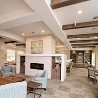 A modern living space with a central fireplace and comfortable seating.