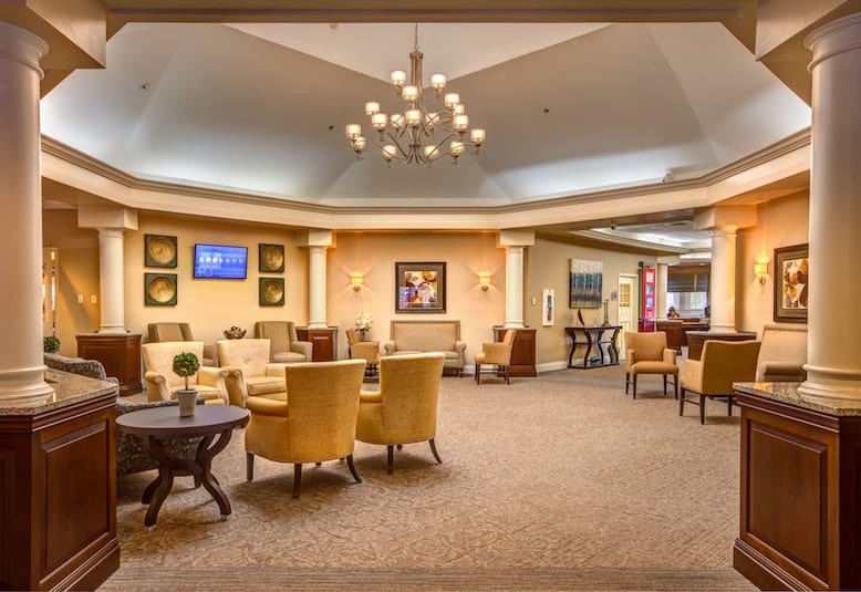 A spacious lobby with elegant seating and a central chandelier.