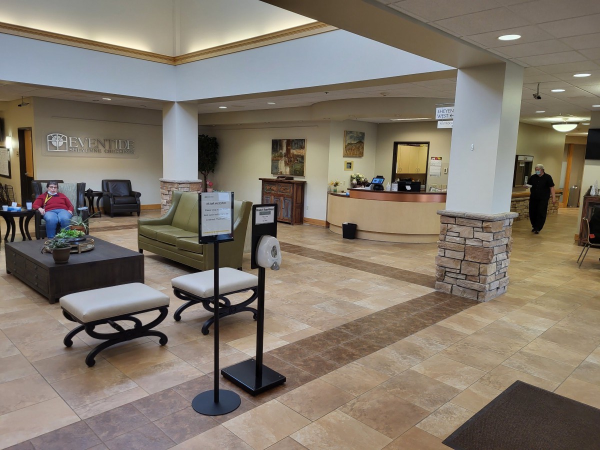A spacious and modern reception area with seating arrangements in a lobby.
