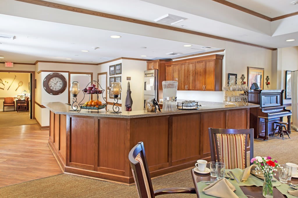 A cozy kitchen and dining area featuring wooden cabinets and elegant decor.