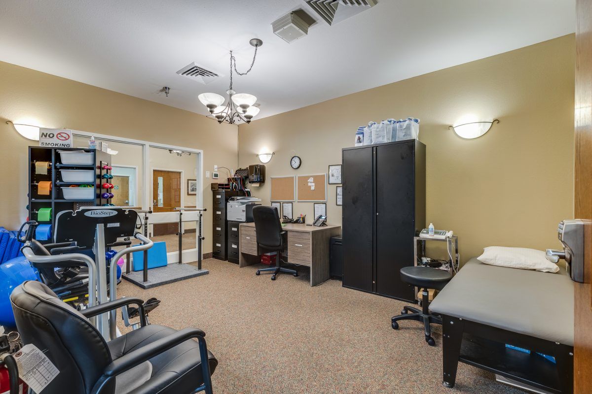 A well-organized office space with multiple desks and seating areas.