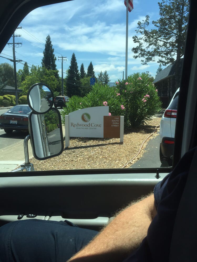 View from inside a vehicle approaching a drive-thru with visible signage.