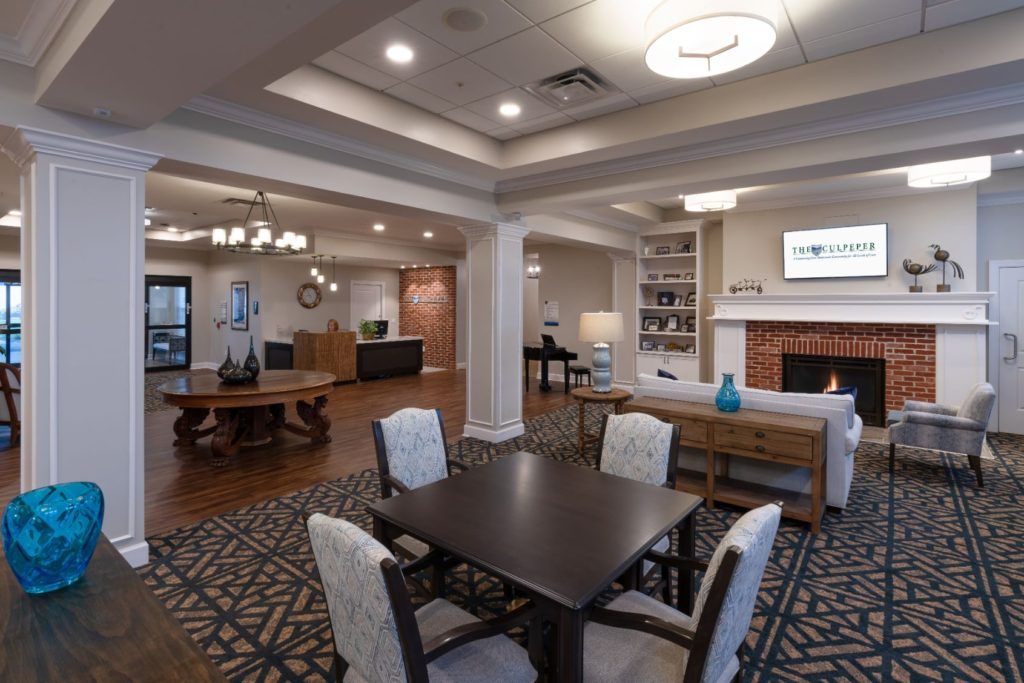 A modern and spacious living area featuring a dining table, fireplace, and comfortable seating.