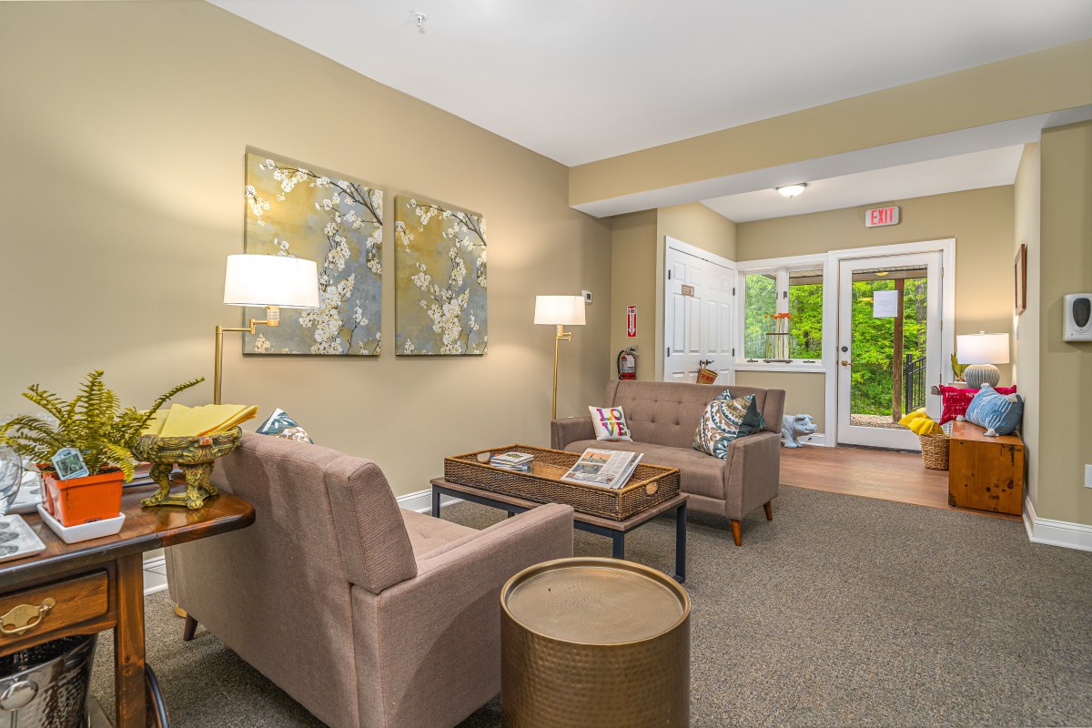 A cozy living room with comfortable seating, artwork, and soft lighting.