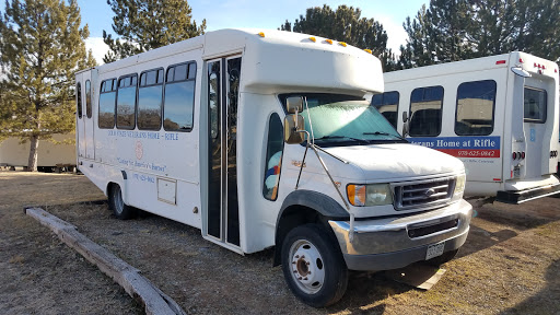 A used white bus parked in a lot, ready for transportation needs.