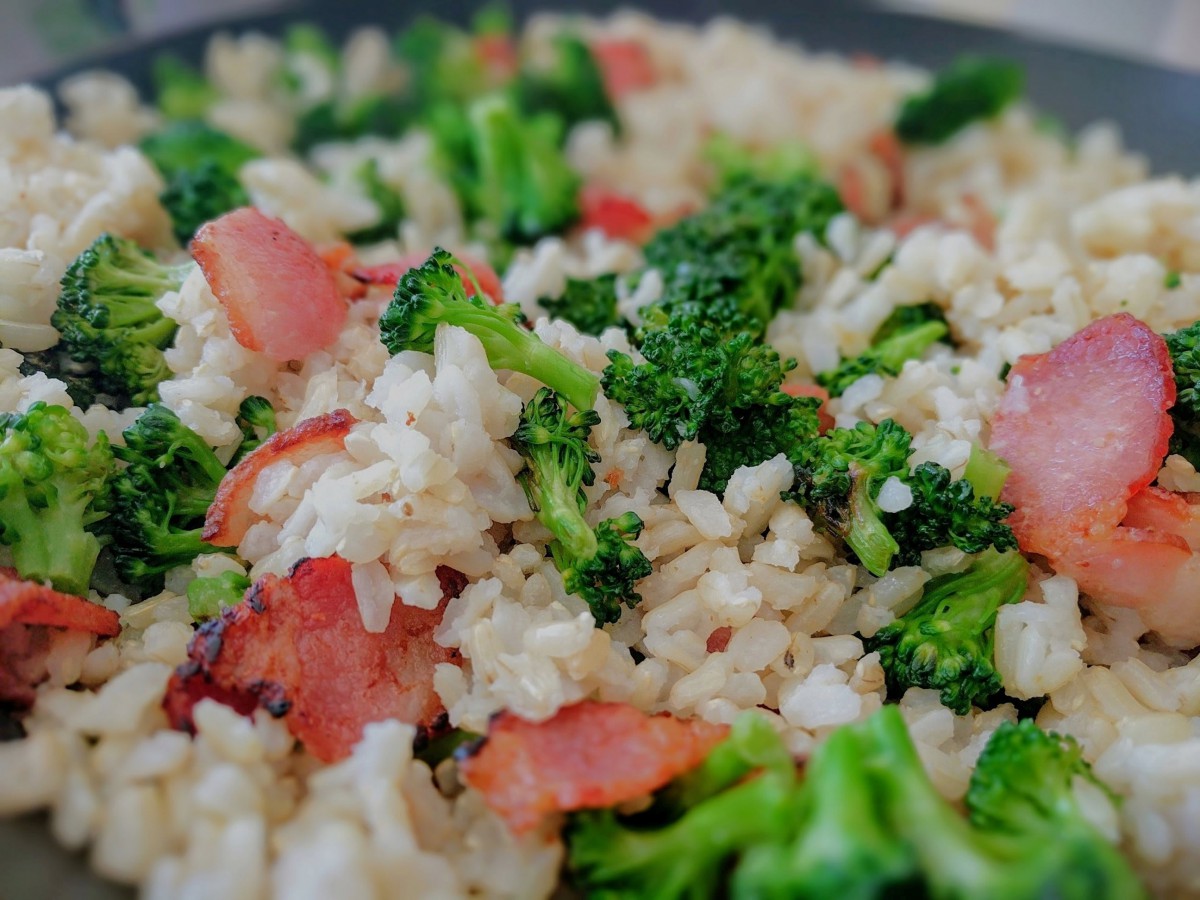A delicious dish of cooked rice with broccoli and bacon.