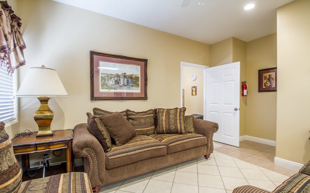 A cozy living room with a comfortable sofa and decorative painting.
