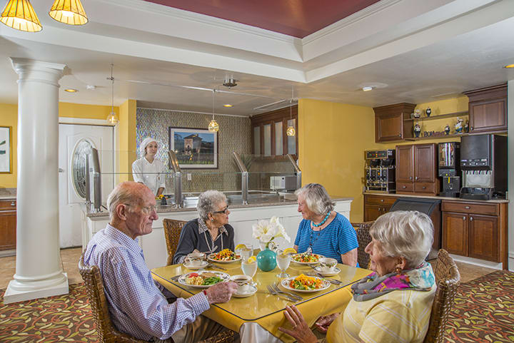 A group of seniors enjoying a meal together in a cozy dining area.
