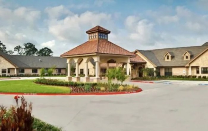 A well-maintained building with a prominent entrance and surrounding landscape.