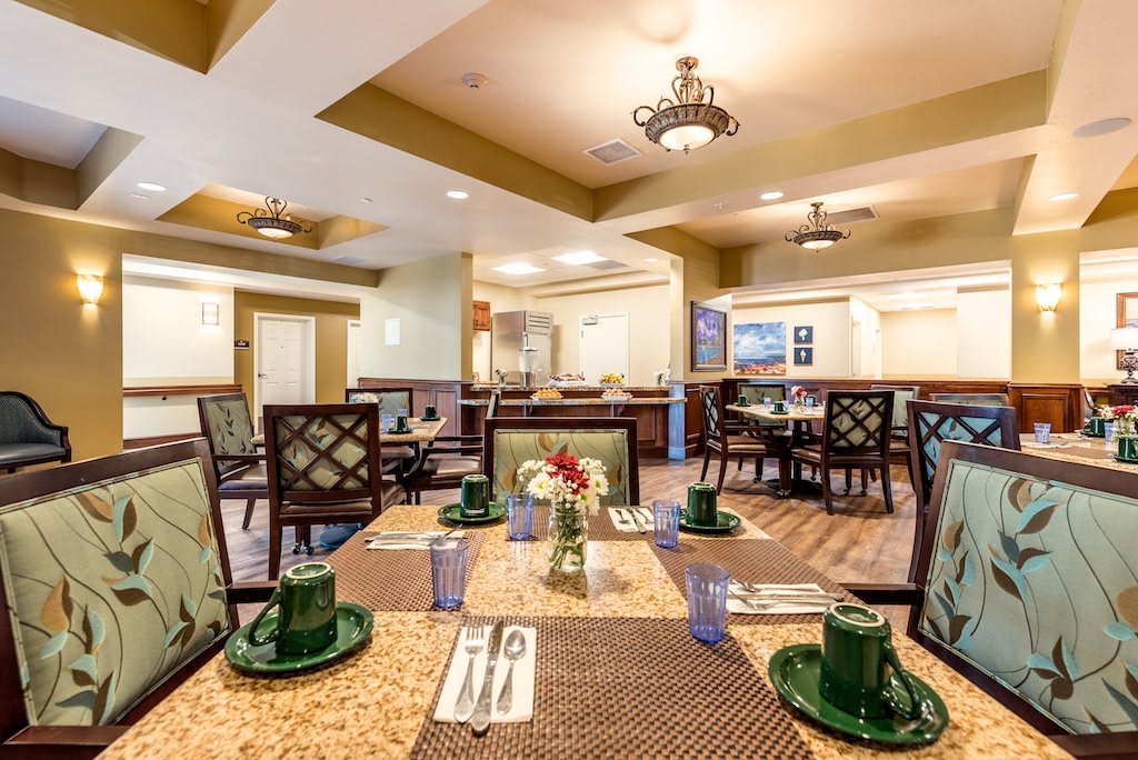 A well-decorated dining area with neatly set tables and elegant interior design.