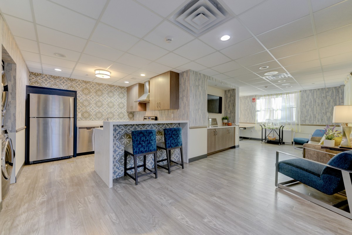 A modern open space kitchen with a breakfast bar and seating area.