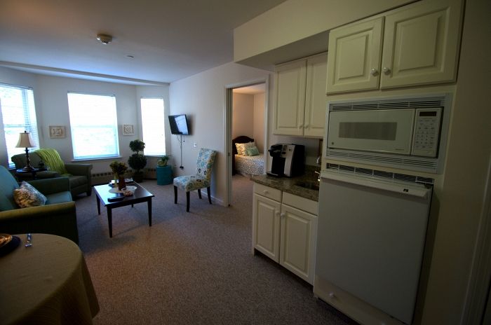 A cozy apartment with a view of the living area and kitchen.
