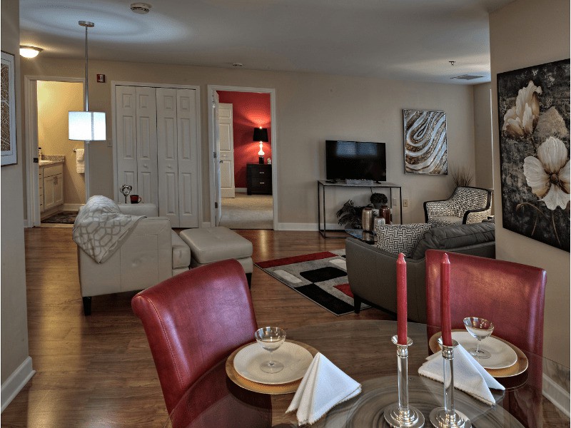 A modern living room featuring a comfortable seating area with a sofa, a television, and an adjacent dining space.