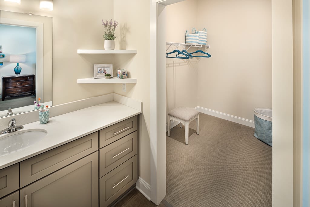 A modern bathroom with a vanity and open shelving for storage.
