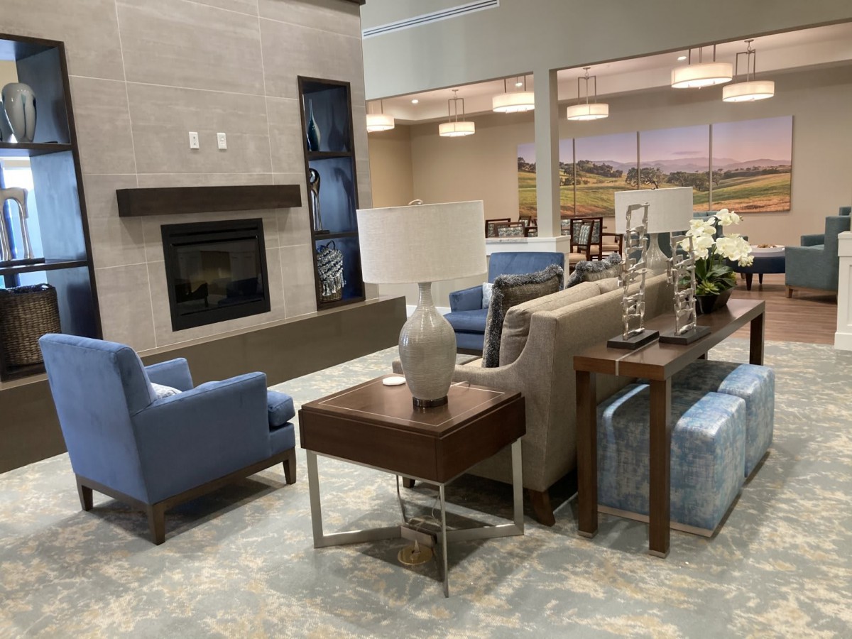 A modern living room with comfortable seating and a cozy fireplace.