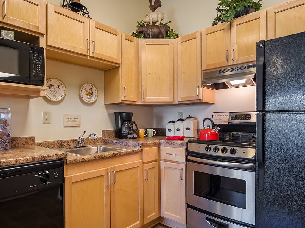A cozy kitchen with wooden cabinets and standard appliances.