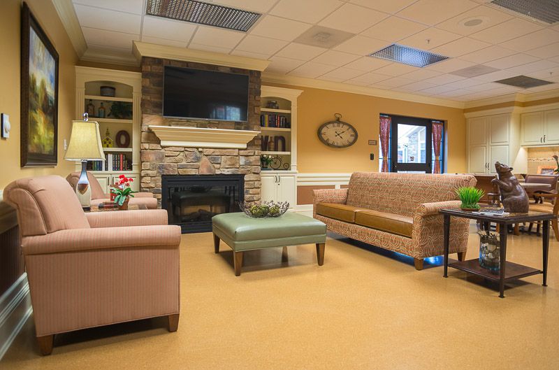 A cozy living room with a fireplace, television, and comfortable seating.