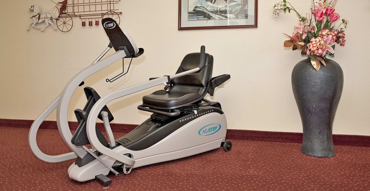 A recumbent exercise bike in an indoor fitness area.