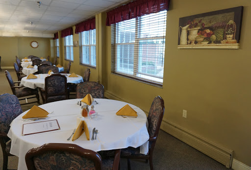 A well-set dining area featuring elegantly arranged tables ready for guests.