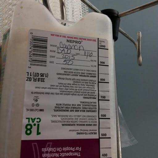 An IV bag hanging with a detailed label for medical use.