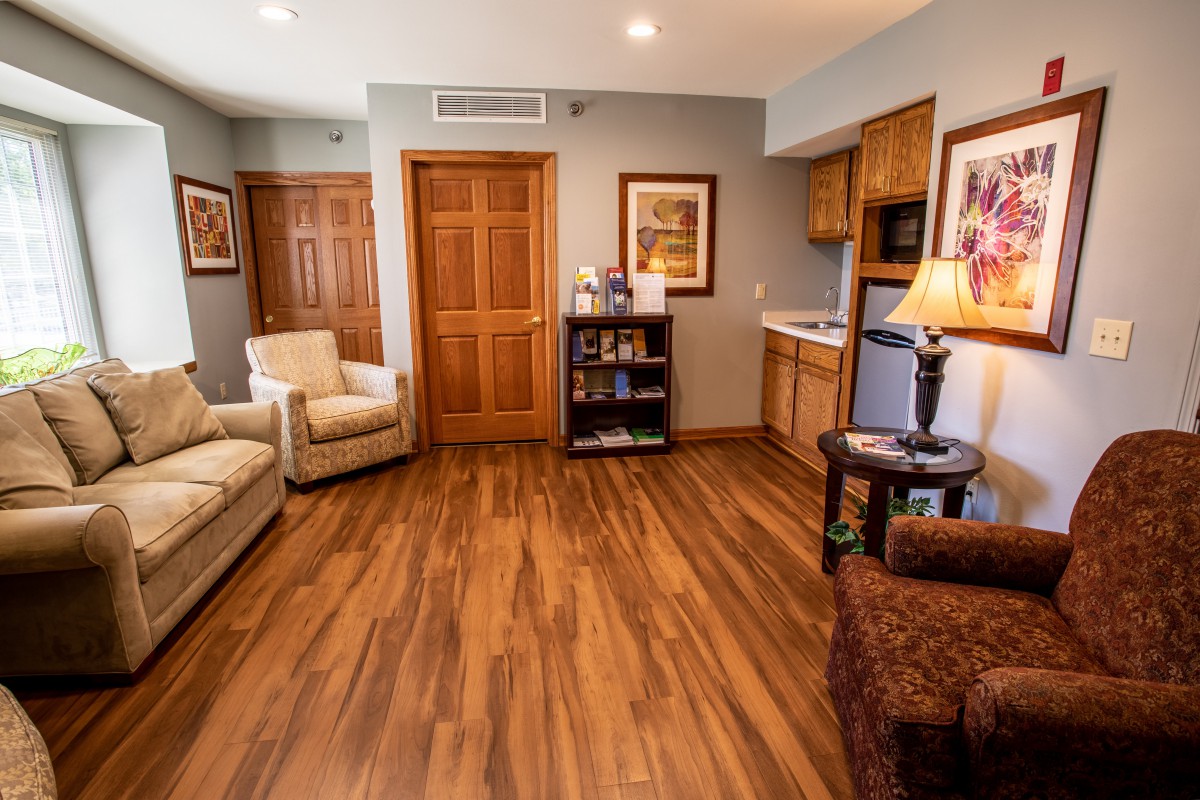 A cozy living room featuring wood flooring, comfortable seating, and tasteful decor.