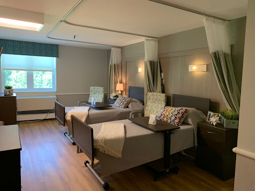 A well-designed hospital room with two patient beds, showcasing a comfortable and inviting atmosphere for recovery.